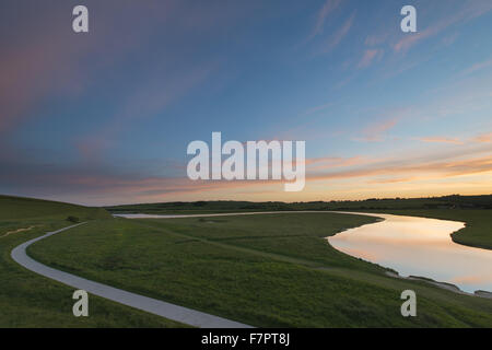 Sunset reflected in the meanders of the Cuckmere River, Cuckmere Valley, East Sussex. Stock Photo