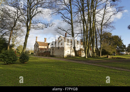View through the trees to the house at Baddesley Clinton, Warwickshire. Stock Photo