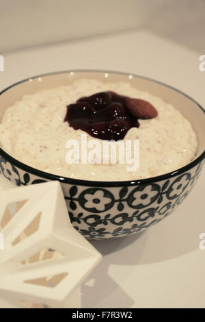 A bowl of 'Risalamande', also known as 'Riz à l'amande' pictured in Copenhagen, Denmark, 29 November 2015. The rice pudding that contains vanilla and a copious amount of whipped cream is traditionally served with cherry sauce for Christmas in Denmark. The person who finds the almond placed into the pudding by the chef is said to have a particularly lucky year ahead of her or him. Photo: JULIA WAESCHENBACH/dpa - NO WIRE SERVICE - Stock Photo