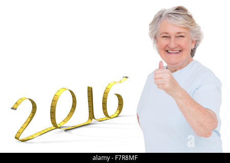 Composite image of senior woman showing thumbs up Stock Photo