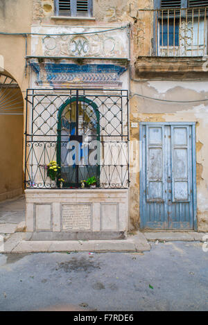 Shrine Italy, a votive niche containing a statue of the Madonna in the old town area of Marsala, Sicily. Stock Photo