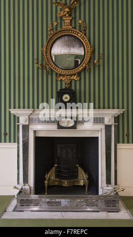 Regency style giltwood mirror hanging above a fireplace, in a room at Polesden Lacey, Surrey. Stock Photo