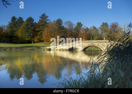 The Oxford Bridge in the autumn at Stowe, Buckinghamshire. Stowe is a landscaped garden with picture-perfect views, winding paths, lakeside walks and classical temples. Stock Photo