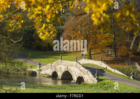 The Oxford Bridge in the autumn at Stowe, Buckinghamshire. Stowe is a landscaped garden with picture-perfect views, winding paths, lakeside walks and classical temples. Stock Photo