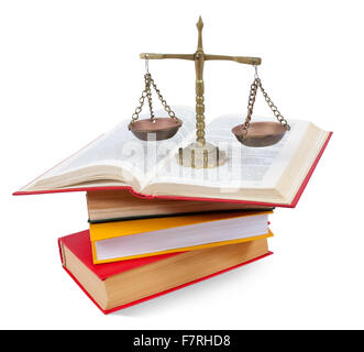 Scales of justice atop legal books. Isolated with clipping path over white background Stock Photo