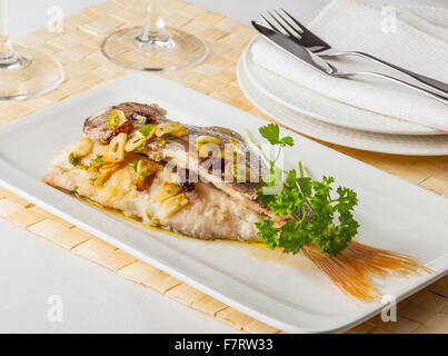 Fried red bream with garlic. Stock Photo