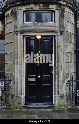 Christmas Wreath on black front door Stock Photo