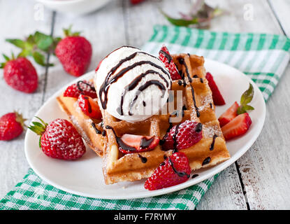 Belgium waffles with strawberries and ice cream on white plate Stock Photo