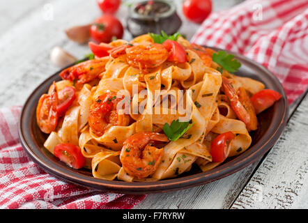 Fettuccine pasta with shrimp, tomatoes and herbs. Top view Stock Photo ...