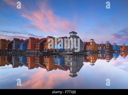 Living at the waterfront: tranquil sunset reflected in a small harbor in the Netherlands. Stock Photo