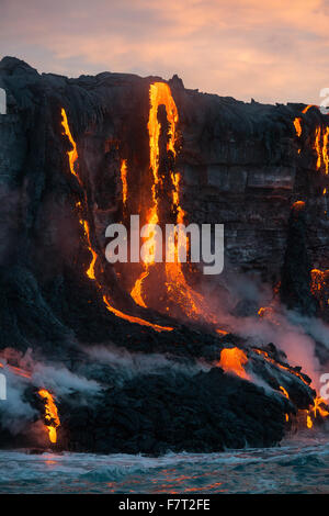 red hot lava from Kilauea Volcano enters the Pacific Ocean at sunrise on Hawaii Island ( the Big Island ), west of Kalapana Stock Photo