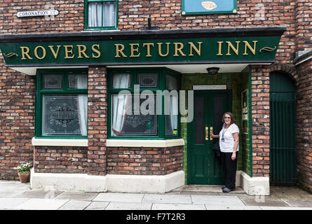 Rovers Return Inn from the popular soap series Coronation Street with the 'Coronation Street' sign on the wall with a fan. Stock Photo