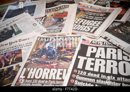 Headlines of New York newspapers over several days, seen on Thursday, November 26, 2015, report on the recent terrorist attacks in Paris leaving over 120 dead. (© Richard B. Levine) Stock Photo