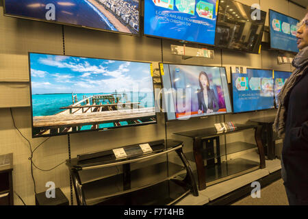 Customers browse Samsung 4K Ultra High Definition televisions in a Best Buy electronics store in New York on Sunday, November 29, 2015. The cost of 4K televisions has come down precipitously this year making them the great hope of retailers as the hot holiday item. (© Richard B. Levine) Stock Photo