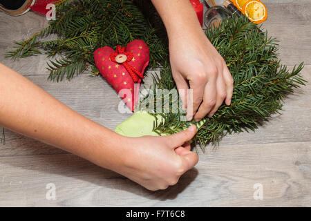Handmade production of Christmas wreaths using weld gun (Shallow DOF). Stock Photo
