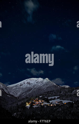 Mountain village at night with starry sky, Nockspitze behind with snow, Kreit, Stubai Valley, Tyrol, Austria Stock Photo