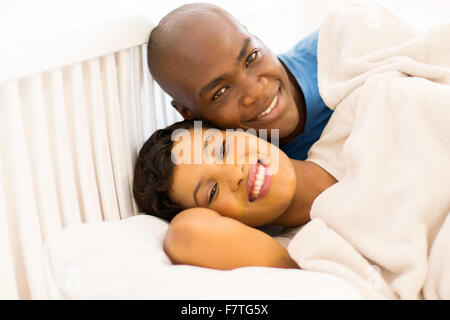 portrait of happy young African couple in bed Stock Photo