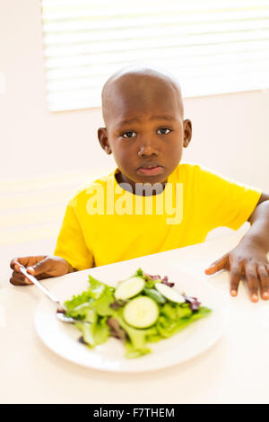 portrait of cute African boy enjoying healthy meal Stock Photo