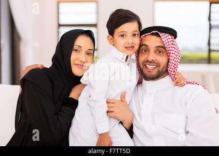 portrait of Arabian couple with their son sitting on couch at home Stock Photo
