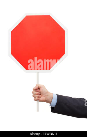 Man's hand in a blue shirt and jacket is holding a red octagon table. The objects are isolated on white background. Stock Photo