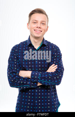 Attractive confident blond man in checkered shirt posing with crossed hands over white background Stock Photo