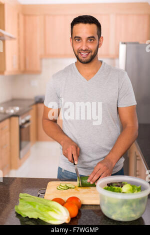modern young Indian man cooking in home kitchen Stock Photo