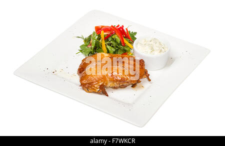 roasted chicken with vegetables on a white plate Stock Photo