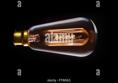 Religion, believe concept in a filament lightbulb. Stock Photo