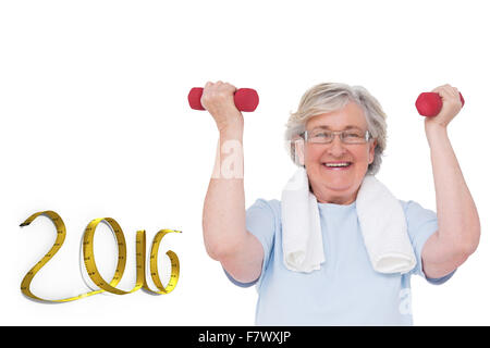 Composite image of senior woman lifting hand weights Stock Photo