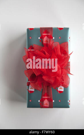 Wrapped Xmas Gift with Red Bow Pom-pom Stock Photo