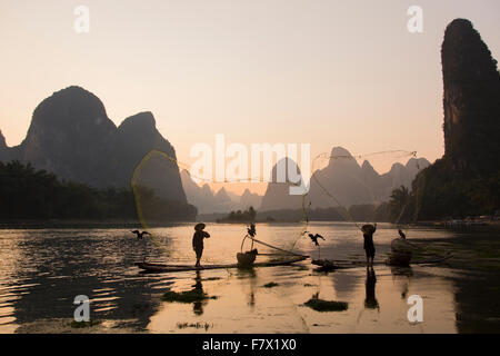 Cormorant Fisherman Throwing Fish Net on River Li Guilin Region Guangxi, China LA008313 Stock Photo