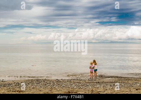 Rear view of Two girls standing on beach