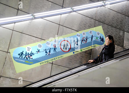 Seoul, South Korea - November 10, 2015 : Lady at escalator of Metropolitan Subway in Seoul, one of the most  used undergrounds Stock Photo