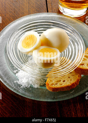 Pickled eggs, traditional British pub food, served with salt and bread Stock Photo