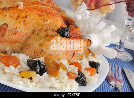 A fragment of grilled chicken with rice and dried fruits closeup Stock Photo