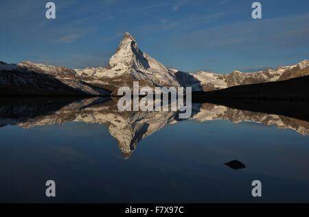 Snow capped Matterhorn mirroring in lake Stellisee Stock Photo