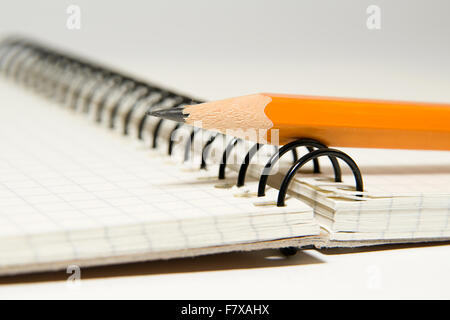 Opened notebook with a blank sheet and pencil on over white Stock Photo