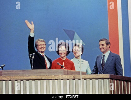 Governor Jimmy Carter (Democrat of Georgia), the 1976 Democratic Party nominee for President of the United States, left, and US Senator Walter Mondale (Democrat of Minnesota), the 1976 Democratic Party nominee for Vice President of the US, right, and their wives Rosalynn Carter, left center, and Joan Mondale, second right, acknowledge the cheers of the delegates following their acceptance speeches at the 1976 Democratic Convention at Madison Square Garden, New York, New York on July 15, 1976. Credit: Arnie Sachs/CNP - NO WIRE SERVICE - Stock Photo