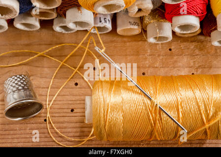 sewing kit on the old wooden desk Stock Photo