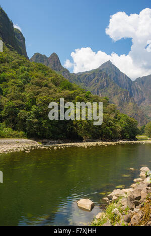 Machu Picchu archeological site viewed on the top in the background from the valley of Urubamba River, covered by lush green jun Stock Photo