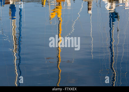 Reflections of sailboat masts in water in Bayfield Wisconsin on Lake Superior Stock Photo