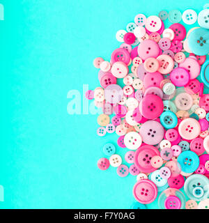 Collection of Colourful Sewing Buttons on Retro Turquoise Background with Copy Space Stock Photo