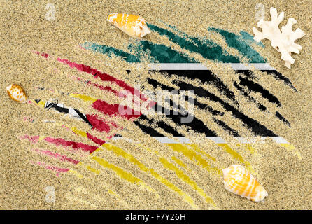 National country flag of Mozambique under a beach background with sand, sea shells and coral Stock Photo