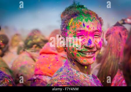 A young woman covered in colored powder during the Holi Festival of Colors at the Sri Sri Radha Krishna Temple March 29, 2014 in Spanish Fork, Utah. The festival follows the Indian tradition of Holi and attracts over 80,000 people. Stock Photo