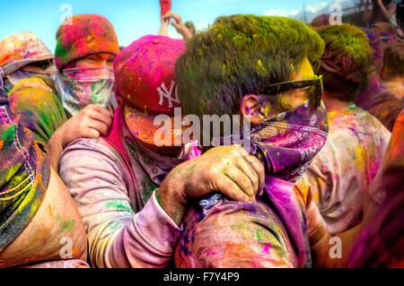 Crowds covered in colored powder bunch together during the Holi Festival of Colors at the Sri Sri Radha Krishna Temple March 30, 2013 in Spanish Fork, Utah. The festival follows the Indian tradition of Holi and attracts over 80,000 people. Stock Photo