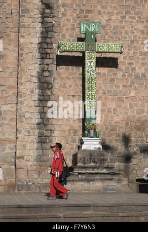 Some children walk near a cross in the facade of the Convent of San Francisco Stock Photo