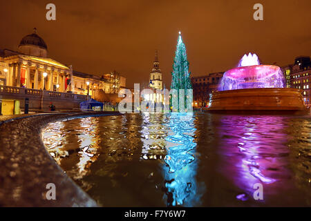 London, UK. 3rd Dec, 2015. Crowds braved the threatening rain to watch the lighting of the Trafalgar Square Christmas Tree in London. The tree is a traditional gift from the people of Norway. Credit:  Paul Brown/Alamy Live News Stock Photo