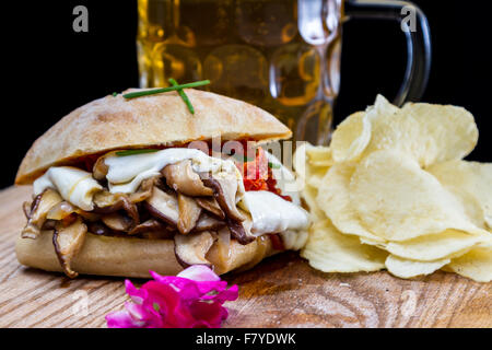 mushroom and cheese sandwich served with a sun dried tomato pesto and potato chips Stock Photo