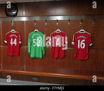 Mix of MUFC shirts hanging up in MUFC dressing room, with MUFC clock, Old Trafford, Manchester