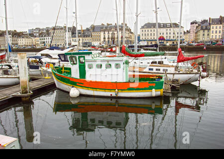 Orange boat in Cherbourg harbour Stock Photo